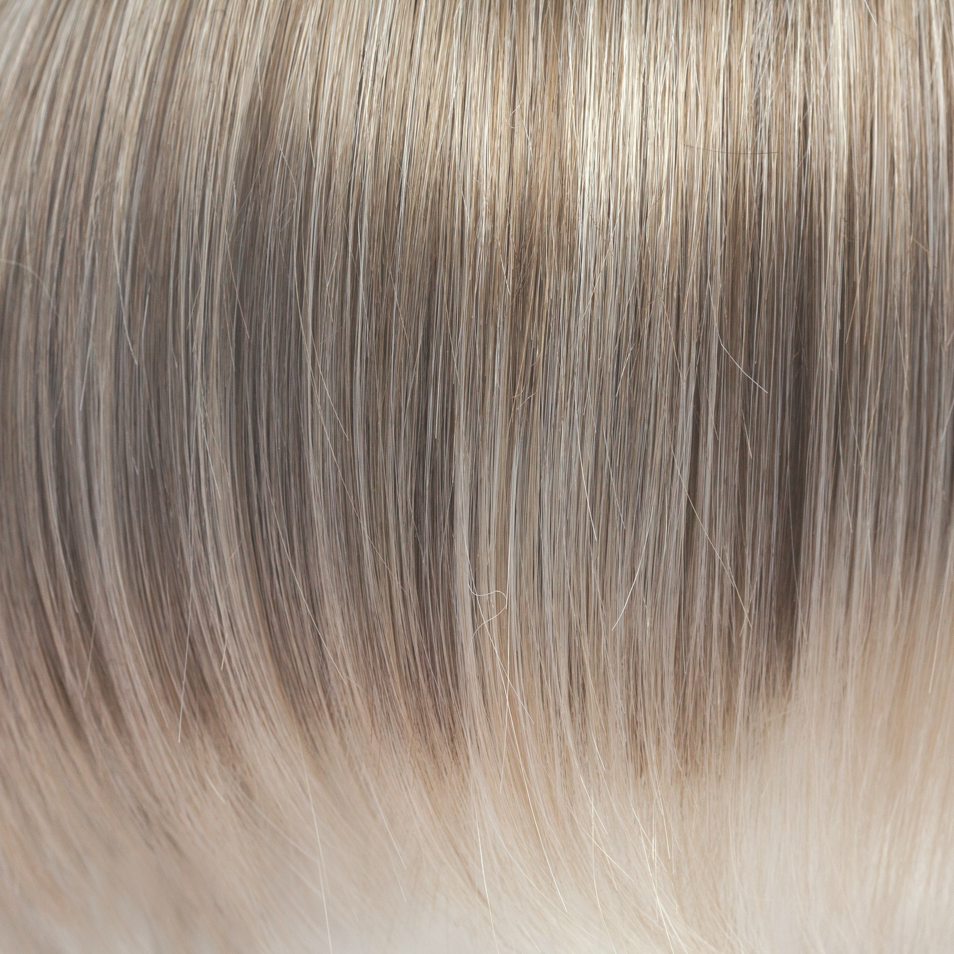 Ice Blond  -  This captivating clever color has a blend of beautiful ash blond highlights and velvet blonds. Towards the ends of the hair you are hit with blocks of ice blonde tips. This Ice Blond color combination is great in any style. It is crisp and cool… we love it!