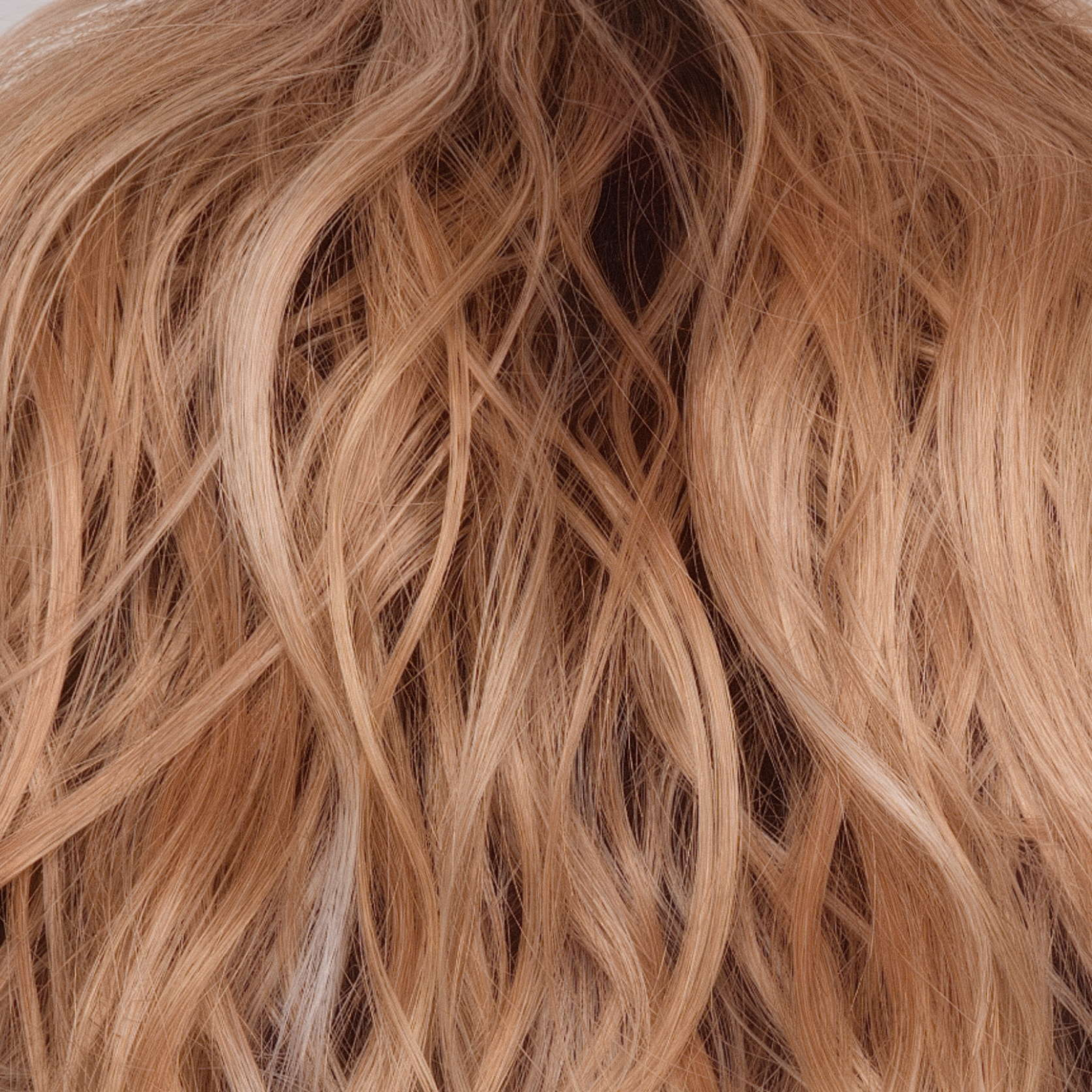 Peaches and Cream  -  A warm peach blonde base with creamy blonde undertone highlights. Face-framing highlights in a bright cream white blonde enhance the look, while a rich chocolate root regrowth adds depth and contrast.
